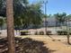 Well-maintained tennis court surrounded by mature trees and lush landscaping in a sunny community at 1017 S Hiawassee Rd # 3735, Orlando, FL 32835