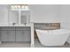 Elegant bathroom featuring double sinks, a soaking tub, and modern fixtures at 12781 Sw 86Th Circle, Ocala, FL 34473