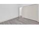 Bedroom featuring gray wood-look flooring and a closet with closed bi-fold doors at 12781 Sw 86Th Circle, Ocala, FL 34473