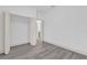 Bright bedroom features gray wood-look flooring and closet with open bi-fold doors at 12781 Sw 86Th Circle, Ocala, FL 34473