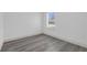 Bedroom features window with blinds and gray wood-look flooring at 12781 Sw 86Th Circle, Ocala, FL 34473