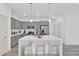 Modern kitchen featuring gray cabinetry, stainless steel appliances, and a large island at 12781 Sw 86Th Circle, Ocala, FL 34473