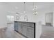 Open concept kitchen with large island, gray cabinetry, stainless steel appliances, and open floor plan at 12781 Sw 86Th Circle, Ocala, FL 34473