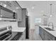 Updated kitchen featuring gray cabinetry, stainless steel appliances and view of living area at 12781 Sw 86Th Circle, Ocala, FL 34473
