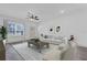 Bright living room with hardwood floors, neutral furniture, and a ceiling fan at 12781 Sw 86Th Circle, Ocala, FL 34473