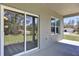 Patio features sliding glass doors, window, and view of lawn at 12781 Sw 86Th Circle, Ocala, FL 34473