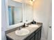 Bathroom with double sink vanity, white framed mirrors and tile flooring at 1337 Ash Tree Cv, Casselberry, FL 32707