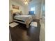 Bedroom boasts hardwood floors, a ceiling fan, and a large bed with shag rugs at 1337 Ash Tree Cv, Casselberry, FL 32707