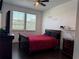 Cozy bedroom featuring a large bed, hardwood floors, and natural light at 1337 Ash Tree Cv, Casselberry, FL 32707