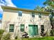 The backyard exterior features a neutral tone and multiple windows against a sunny sky at 1337 Ash Tree Cv, Casselberry, FL 32707