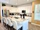 Bright eat-in kitchen with white cabinetry, granite countertops, large island with seating, and stainless steel appliances at 1337 Ash Tree Cv, Casselberry, FL 32707