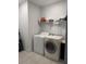 Laundry room with washer, dryer, shelving, and tiled flooring at 1337 Ash Tree Cv, Casselberry, FL 32707