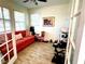 Bright office space with French doors, tile flooring, and a comfortable sofa, perfect for working from home at 1337 Ash Tree Cv, Casselberry, FL 32707