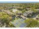 Beautiful aerial view of the community featuring tennis courts, a lake, a pool, and well-maintained landscaping at 15 Escondido Ct # 145, Altamonte Springs, FL 32701