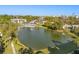 Overhead view of a tranquil lake featuring a fountain and community pool, all surrounded by condos and greenery at 15 Escondido Ct # 145, Altamonte Springs, FL 32701