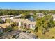 An aerial view of the community and surrounding landscape, including the lake at 15 Escondido Ct # 145, Altamonte Springs, FL 32701