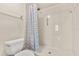 Bathroom featuring a walk-in shower, toilet, and decorative shower curtain at 15 Escondido Ct # 145, Altamonte Springs, FL 32701