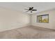This bedroom features neutral carpet, ceiling fan, and natural light from a window at 15 Escondido Ct # 145, Altamonte Springs, FL 32701