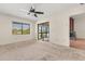 Bright bedroom with neutral carpet, ceiling fan, and access to the sunroom at 15 Escondido Ct # 145, Altamonte Springs, FL 32701