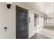 Exterior doorway featuring textured walls, with dark metal door and door number at 15 Escondido Ct # 145, Altamonte Springs, FL 32701