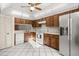 Kitchen featuring modern appliances, dark wood cabinetry, and white tile floor at 15 Escondido Ct # 145, Altamonte Springs, FL 32701