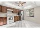 Bright kitchen featuring white tile floors, modern stainless steel appliances, and wood cabinets at 15 Escondido Ct # 145, Altamonte Springs, FL 32701