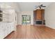 Open living room with hardwood floors, fireplace, and sliding glass doors to the patio at 15 Escondido Ct # 145, Altamonte Springs, FL 32701