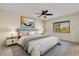 This primary bedroom features a ceiling fan, neutral walls, and two side tables at 15 Escondido Ct # 145, Altamonte Springs, FL 32701