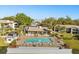 Community pool with ample seating overlooking the lake and manicured grounds at 15 Escondido Ct # 145, Altamonte Springs, FL 32701