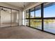 Sunroom with sliding glass doors, scenic water view, and convenient closet access at 15 Escondido Ct # 145, Altamonte Springs, FL 32701
