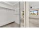 Walk-in closet with adjustable rods for storage and access to bedroom with natural light at 15 Escondido Ct # 145, Altamonte Springs, FL 32701