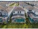 Aerial view of a home featuring a private screened-in pool, blending luxury and comfort at 1565 Mulligan Blvd, Davenport, FL 33896