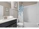 Clean bathroom with a single sink vanity, a stylish mirror, and a shower-tub combo at 1565 Mulligan Blvd, Davenport, FL 33896