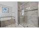 Bathroom features glass shower, marble tub, and modern fixtures at 1565 Mulligan Blvd, Davenport, FL 33896