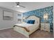 Bedroom features white wood bed, blue accent wall, ceiling fan, and carpeted floors at 1565 Mulligan Blvd, Davenport, FL 33896