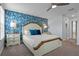 Bedroom features white wood bed, blue accent wall, ceiling fan, and carpeted floors at 1565 Mulligan Blvd, Davenport, FL 33896