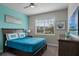Comfortable bedroom with stylish furniture, a ceiling fan, and a window with pleasant community views at 1565 Mulligan Blvd, Davenport, FL 33896