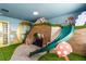 Playful bedroom with a fun custom built bed, slide and decor at 1565 Mulligan Blvd, Davenport, FL 33896