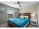 Comfortable bedroom with accent wall, stylish furniture, a ceiling fan, and a window for plenty of natural light at 1565 Mulligan Blvd, Davenport, FL 33896