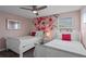Bedroom features two beds, ceiling fan, carpeted floors, and accent wall at 1565 Mulligan Blvd, Davenport, FL 33896