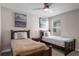Bedroom features two beds, ceiling fan, carpeted floors, and bedside table at 1565 Mulligan Blvd, Davenport, FL 33896