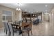 Open-concept dining area with modern lighting and access to the kitchen, great for Gathering meals and entertaining at 1565 Mulligan Blvd, Davenport, FL 33896
