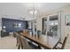 Elegant dining room featuring a modern chandelier and seamless transition to the living area and backyard at 1565 Mulligan Blvd, Davenport, FL 33896