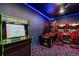 Fun game room with arcade games and blue lighting for an immersive experience at 1565 Mulligan Blvd, Davenport, FL 33896