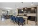 Spacious kitchen and dining area with a large island and seating for four at 1565 Mulligan Blvd, Davenport, FL 33896
