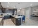 Stylish kitchen with stainless steel appliances and a large island with bar stool seating at 1565 Mulligan Blvd, Davenport, FL 33896