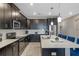 Modern kitchen features stainless appliances, black cabinets, and white tile backsplash at 1565 Mulligan Blvd, Davenport, FL 33896