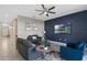 Stylish living room features modern decor, a bold accent wall, and bright, natural light at 1565 Mulligan Blvd, Davenport, FL 33896