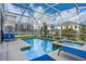 Sparkling backyard pool and relaxing hot tub with plenty of lounge seating in a screened enclosure at 1565 Mulligan Blvd, Davenport, FL 33896