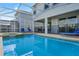 Private screened-in pool and spa area with secure fencing, ideal for Gathering fun and relaxation at 1565 Mulligan Blvd, Davenport, FL 33896